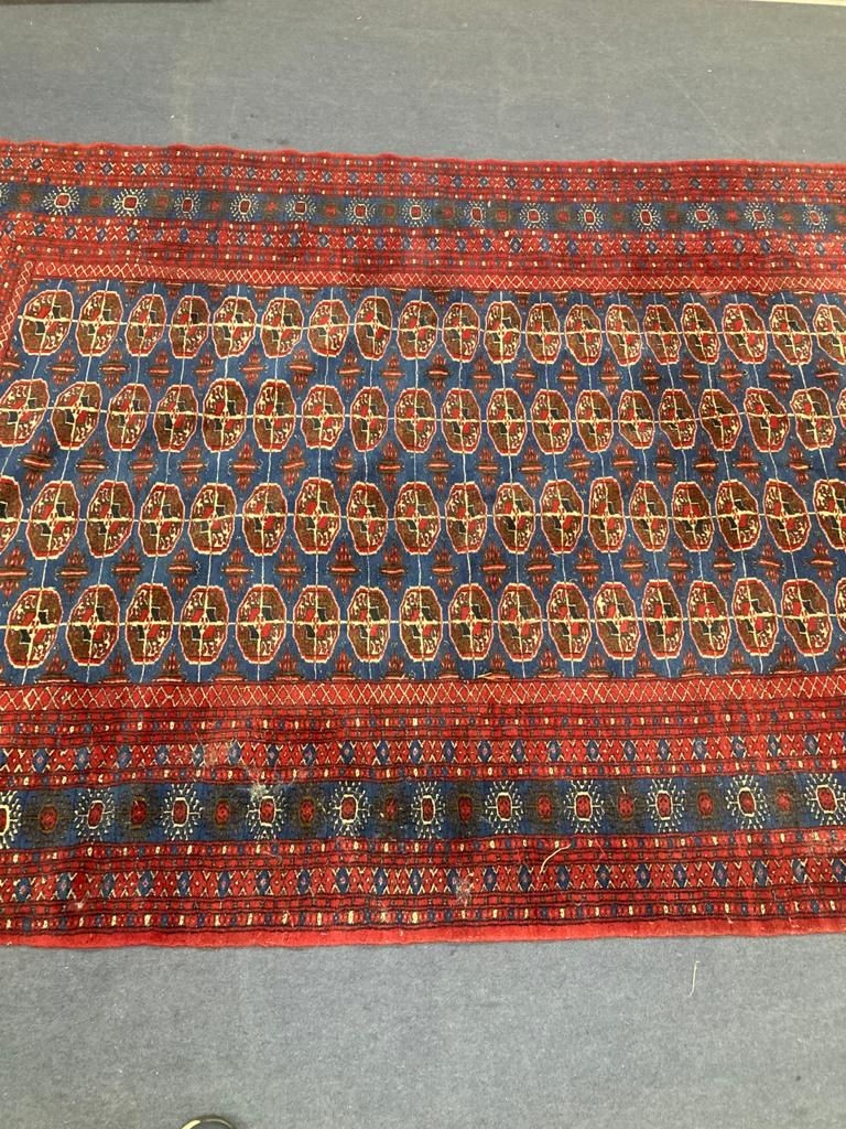 A Bokhara blue ground carpet. 240x150.